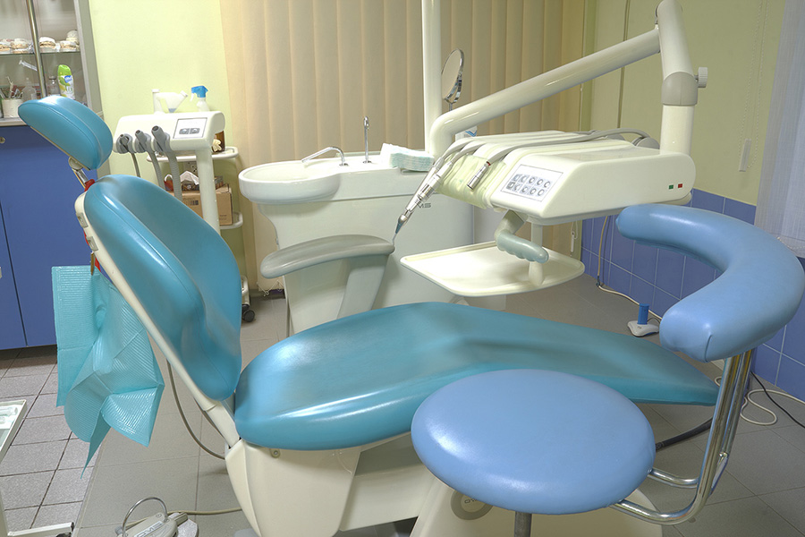 Modern dentist’s chair in a medical room.